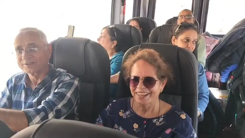 Our guests smiling in the reclining seats of the Gemini Urbania on a Spiti trip